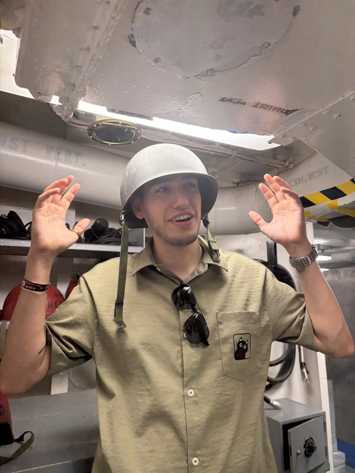 Renilson smiling in a helmet with both hands raised